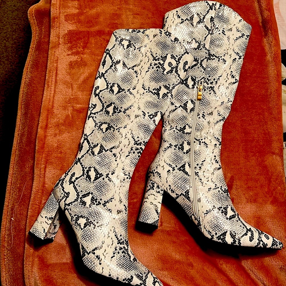 Snake skin print faux leather knee high boots.